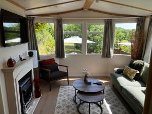 a living room with a couch and a table at Devon Tor View Country Retreat in Bratton Clovelly