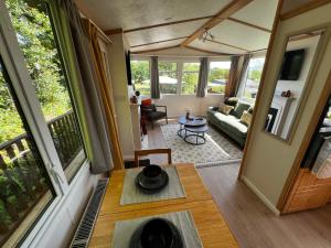 a living room with a table and a couch at Devon Tor View Country Retreat in Bratton Clovelly