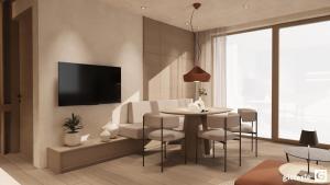 a living room with a table and chairs and a tv at Augusta Apartments in Fliess