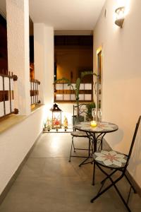 a dining room with a table and chairs and a hallway at La Rosa di Antonio & Relax Room in Tricase