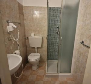 a bathroom with a shower and a toilet and a sink at Hotel Genzianella in Florence