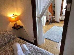 a bedroom with a bed and a room with a window at La casina de La Fragua in Lastres