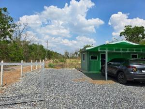 a car parked in front of a green shed at ชนแดนวิวเขา in Chon Daen +4 photos