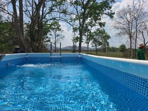 a large blue swimming pool with water in it at ชนแดนวิวเขา in Chon Daen