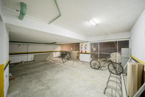 a room with two bikes parked in a garage at Cinema no Quarto: Smart TV 65", Piscina e Colado no Shopping! in Joinville