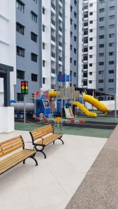 a playground with two benches and a slide at Afa Homestay Melaka in Malacca