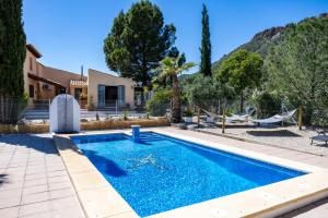 a swimming pool in a yard with a house at Casa Sabor de la Vida in Abarán