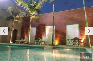 a house with a swimming pool next to a building at Oasis Tower Hotel in Ribeirão Preto