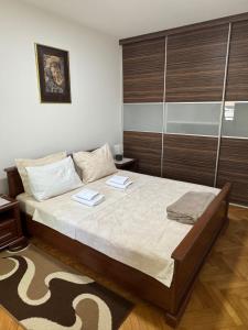 a bedroom with a bed with two books on it at M&G centar grada in Požarevac
