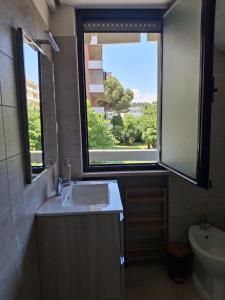 a bathroom with a sink and a window at BubiBea in Silvi Marina +18 photos