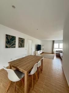 a living room with a wooden table and chairs at Apartamentos La Janda in Benalup Casas Viejas