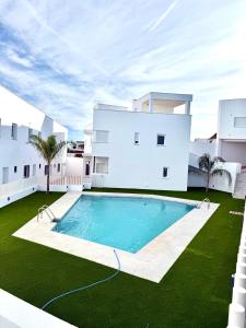 a swimming pool in front of a building at Apartamentos La Janda in Benalup Casas Viejas