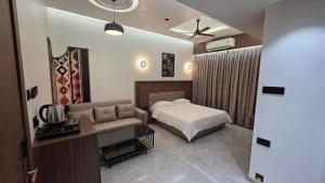 a hotel room with a bed and a couch at Sky Grand Stays in Ulhāsnagar