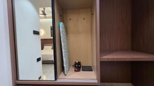 a room with a closet with a mirror and a bed at Sky Grand Stays in Ulhāsnagar