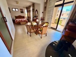 a living room with a table and chairs and a bedroom at Villa Luck in Trou aux Biches