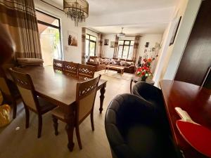 a living room with a wooden table and chairs at Villa Luck in Trou aux Biches