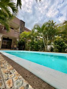 a swimming pool in front of a house at Villa Luck in Trou aux Biches