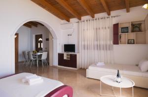 a living room with a couch and a table at Vila Dena in Vlorë
