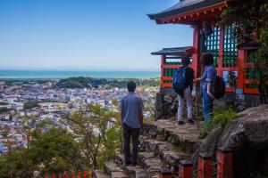 a group of people looking out over a city at KAMIKURA stay in Shingū +7 photos