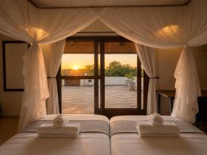 a bedroom with a bed with two towels on it at Amazing mountain views! Solar powered! in Hoedspruit