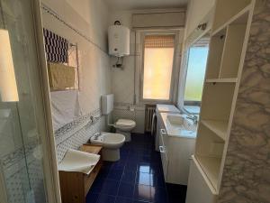a small bathroom with a toilet and a sink at Montegrappa smart stay Modena in Modena