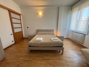 a bedroom with a bed with two towels on it at Montegrappa smart stay Modena in Modena