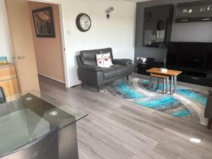 a living room with a chair and a table at Central Mablethorpe Apartment in Mablethorpe