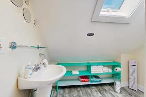 a bathroom with a sink and a blue shelf at East End Annex in Portland