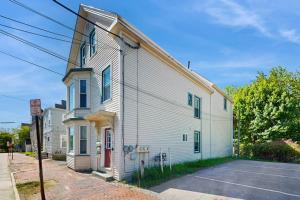 a white building with a red door on a street at East End Annex in Portland