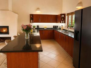 a kitchen with a black refrigerator and a counter at Amazing mountain views! Solar powered! in Hoedspruit