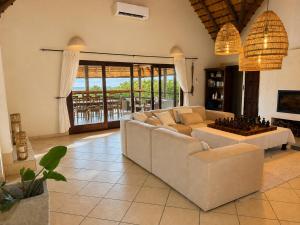 a living room with a couch and a chess board on a table at Amazing mountain views! Solar powered! in Hoedspruit