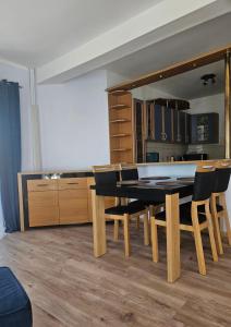 a dining room with a table and chairs at Apartament Kościuszki in Malbork +18 photos