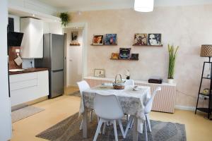 a kitchen and dining room with a table and chairs at 10 min from the lake, Spacious & Modern - Lalaland in Porto Ceresio