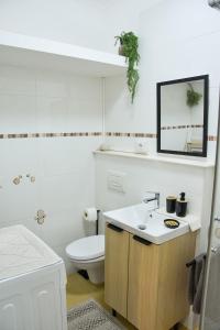 a white bathroom with a toilet and a sink at 10 min from the lake, Spacious & Modern - Lalaland in Porto Ceresio +31 photos
