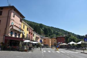 a street in a town with a mountain at 10 min from the lake, Spacious & Modern - Lalaland in Porto Ceresio