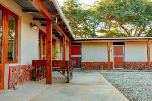 a porch of a house with a red bench at Best for last resorts in Kalkheuvel