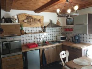 a kitchen with a sink and a stove top oven at Wigierska Chatka in Gawrych Ruda