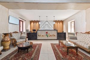 a living room with two couches and a television at Ichan Qal'a Premium Class Hotel in Tashkent