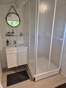 a bathroom with a shower and a sink at Utsikten Bjerkøya - Where the View Meets the Sea, app 1h from Oslo in Holmestrand