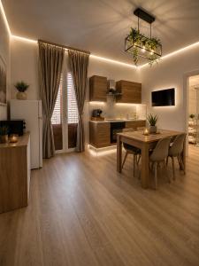 a living room with a table and a kitchen at Sicily Luxury Apartments in Palermo +33 photos