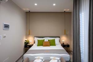 a bedroom with a large bed with green pillows at Alba Stays in Ladispoli
