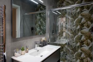 a bathroom with a sink and a shower with a mirror at Alba Stays in Ladispoli +55 photos