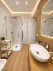 a bathroom with a white sink and a shower at Sicily Luxury Apartments in Palermo