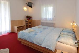 Postel nebo postele na pokoji v ubytování Hotel Zanon