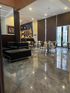 a lobby with couches and tables in a building at Habor Hotel & Suites- Abuja in Abuja