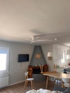 a living room with a table and a tv at Apartaments La Pertusa 1 in Corçà