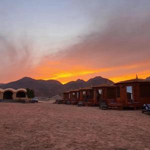 a group of huts in the desert at sunset at Nour camp in Nuweiba +27 photos