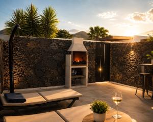 a backyard patio with a fireplace and a fire pit at Villa Blanco - Romantic Hideaway - Private Villa for Couple in Tías