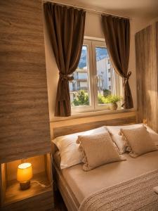 a bedroom with a bed and a window at Johanan in Makarska