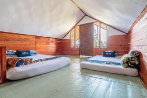 a room with two beds in a tent at TB Villa Resort By ARBA in Palayangan +36 photos
